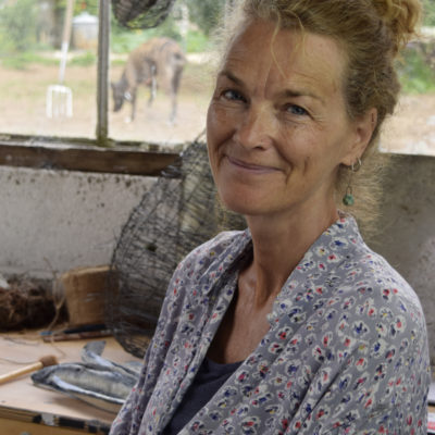 Alison Shelton Brown in studio, wearing a blue floral shirt.